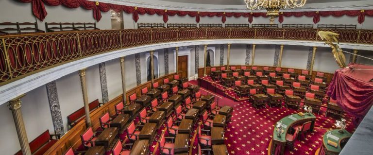 Senate chamber floor with senators debating and filibuster procedural chart